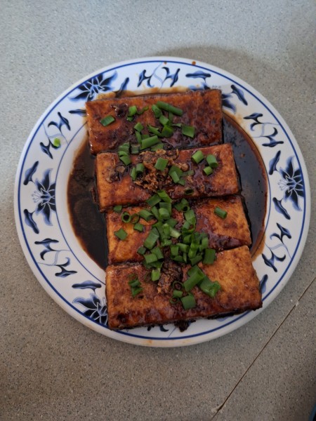 Teriyaki Tofu Steak with green onon garnish.  The green onions are from my yard.