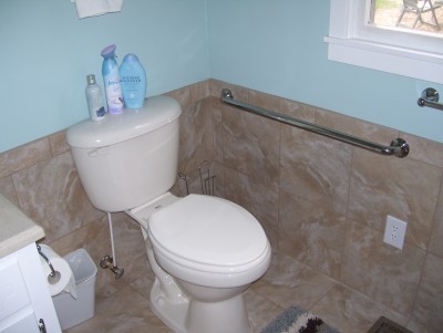 ADA toilet with tile wall and safety bars